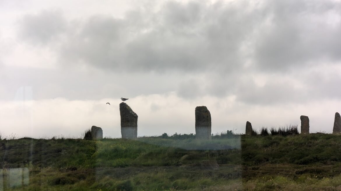 Ring of Brodgar, Neolithic stone circle, Orkney, UNESCO World Heritage Site, standing stones, 13 feet tall, 2500 BCE, mystical atmosphere, prehistoric communities, rituals, gatherings, earth bank, ditch, Stonehenge, Standing Stones of Stenness, free access, cultural heritage, spiritual beliefs, ancient site